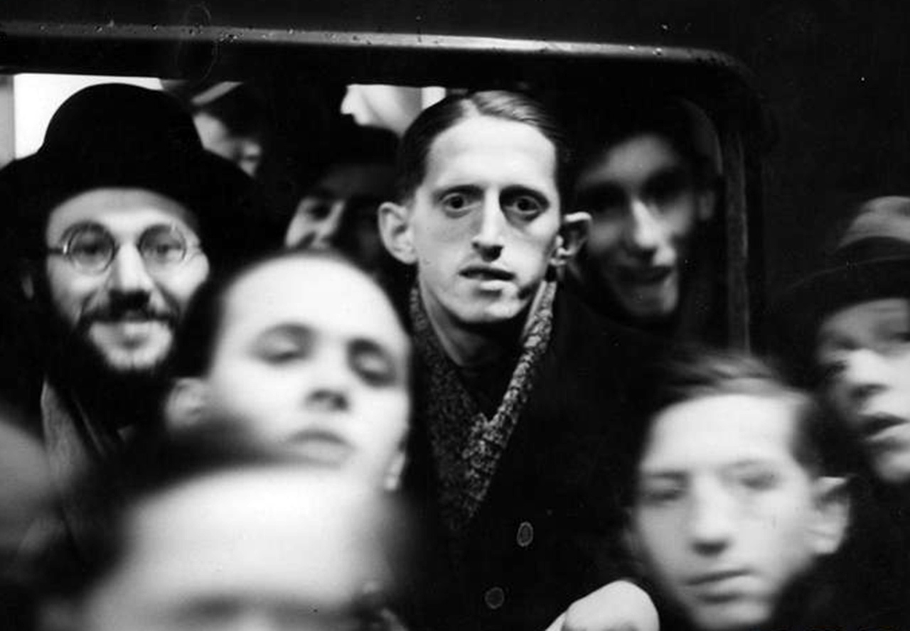 Żydzi wyjeżdżający do Palestyny w oknie wagonu kolejowego. Wśród nich widoczny mistrz Polski w tenisie stołowym z 1936 roku Finkelsztajn, 15 lutego 1937 r. Źródło: NAC